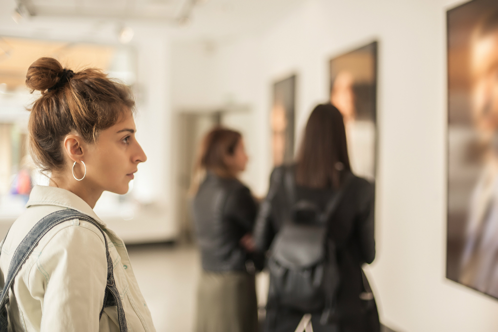 Investing in art Photo of a woman looking at paintings in an art gallery.
