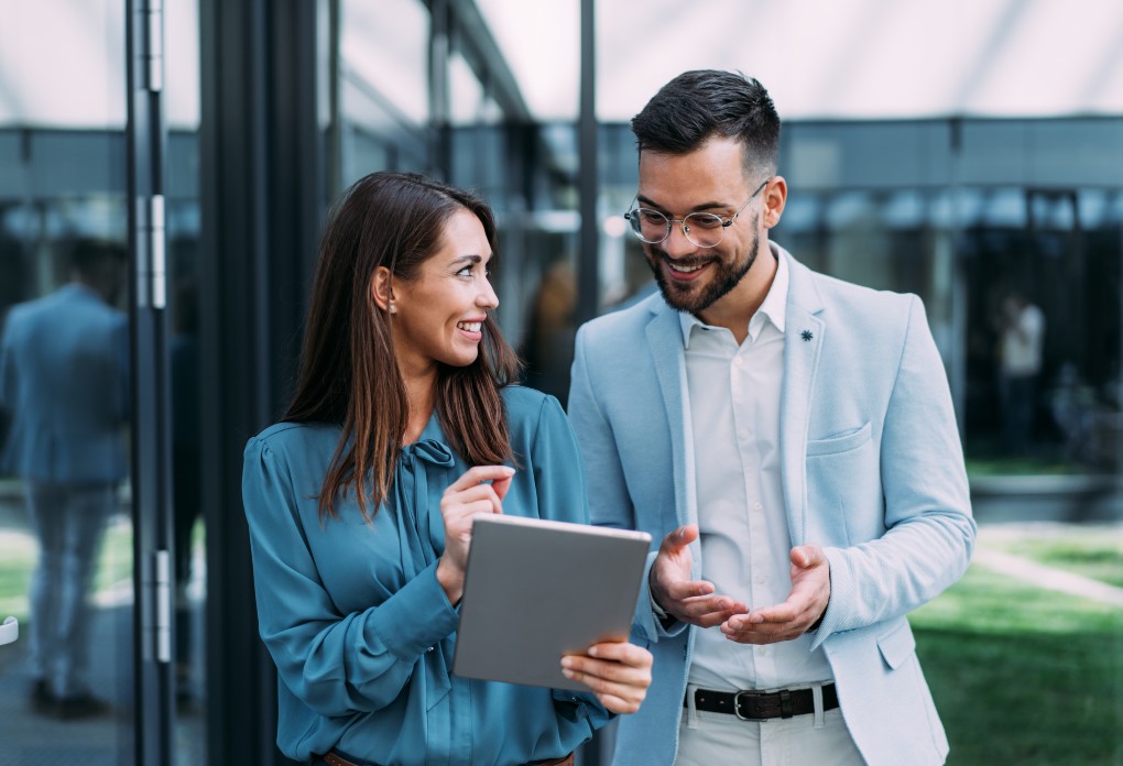 A man and a woman consulting the performance of their quality stocks on their tablet.