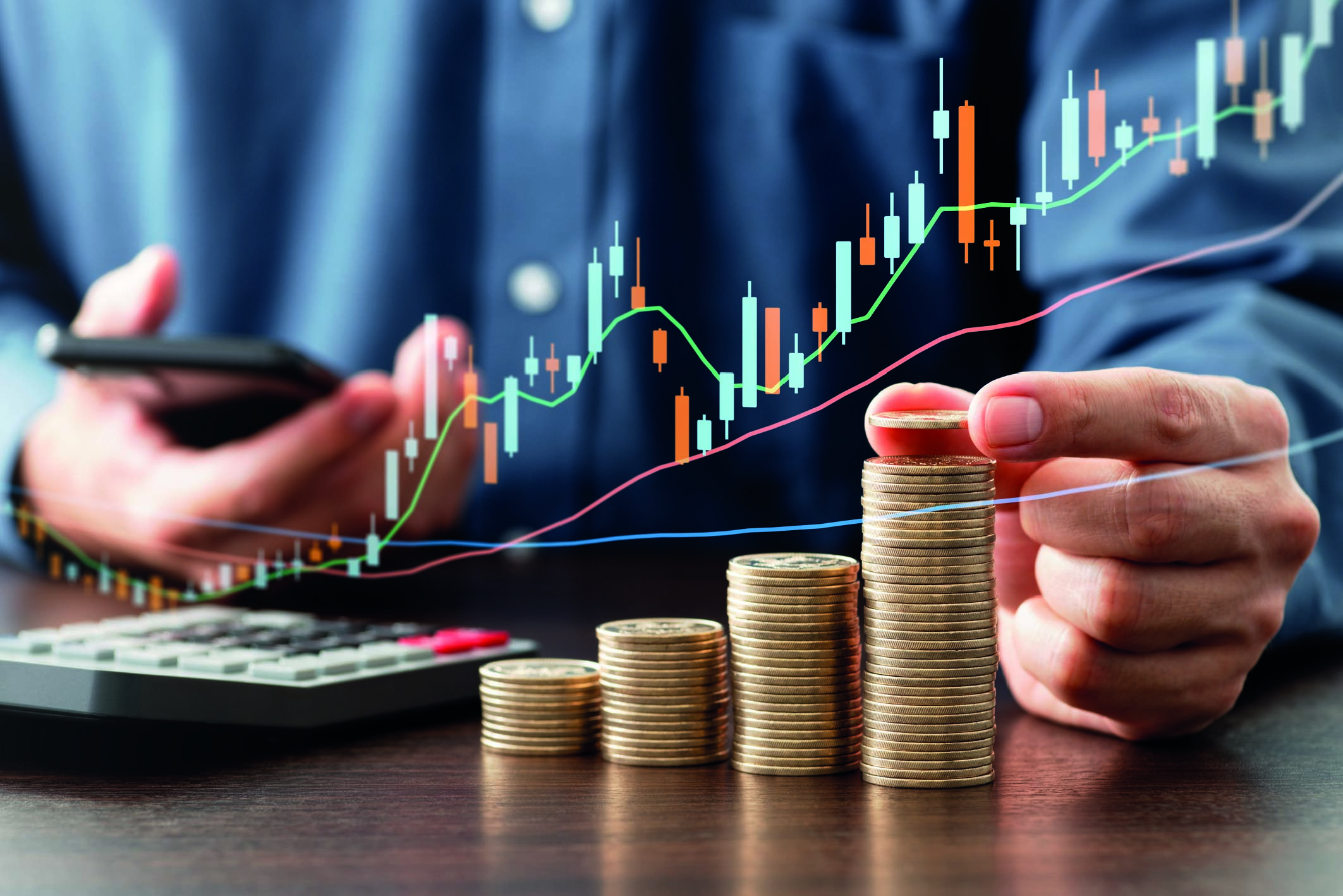 A person calculating his money in a pile making it a chart