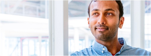 Photo of a man listening to someone in an office