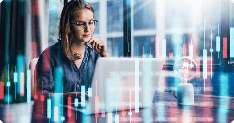 Photo of a woman in front of her laptop with an effect of superimposed graphics 