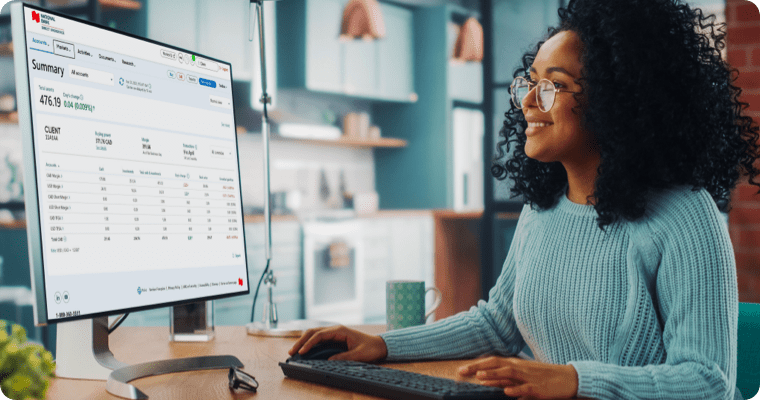Photo of a woman looking at a large computer screen