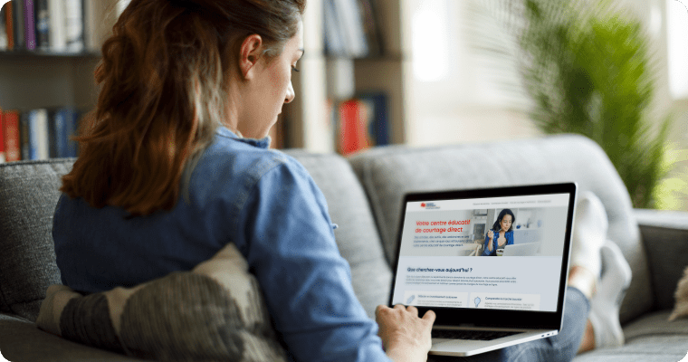 Photo of a woman on a sofa working on their laptop
